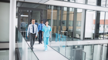 Doctors and nurse walking in corridor at hospital